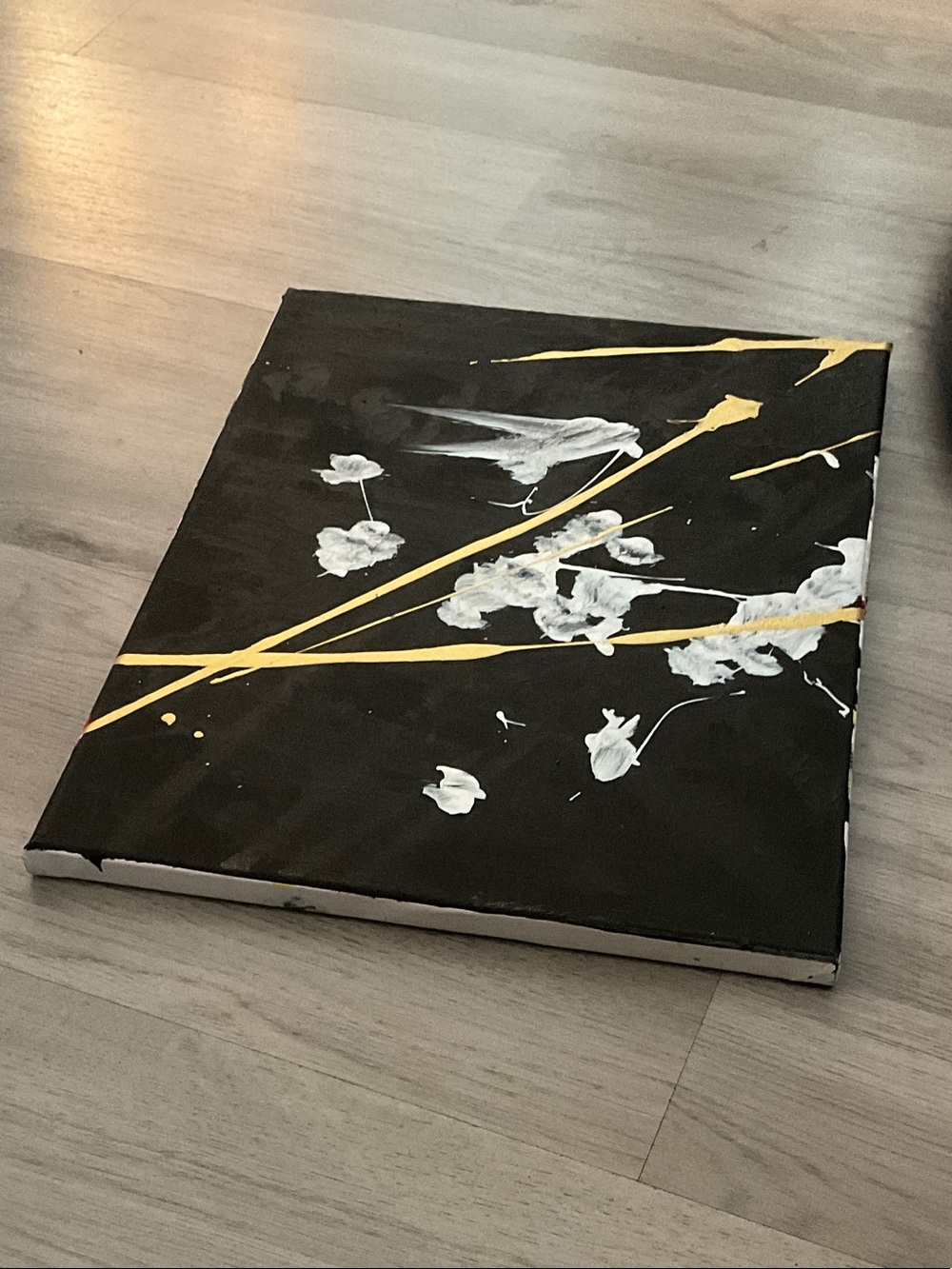 Contemporary Black Canvas Art with Gold Accents and White Floral Strokes